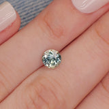 Sapphire | natural, light teal color/color changing, round-cut, *6mm, 1.1ct