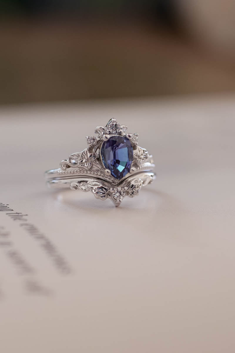 Ariadne style engagement ring and wedding ring in white gold, Cantral gemstone is pear cut alexandrite, side stones are man made or natural diamonds, round cut, leaves ring in gold.