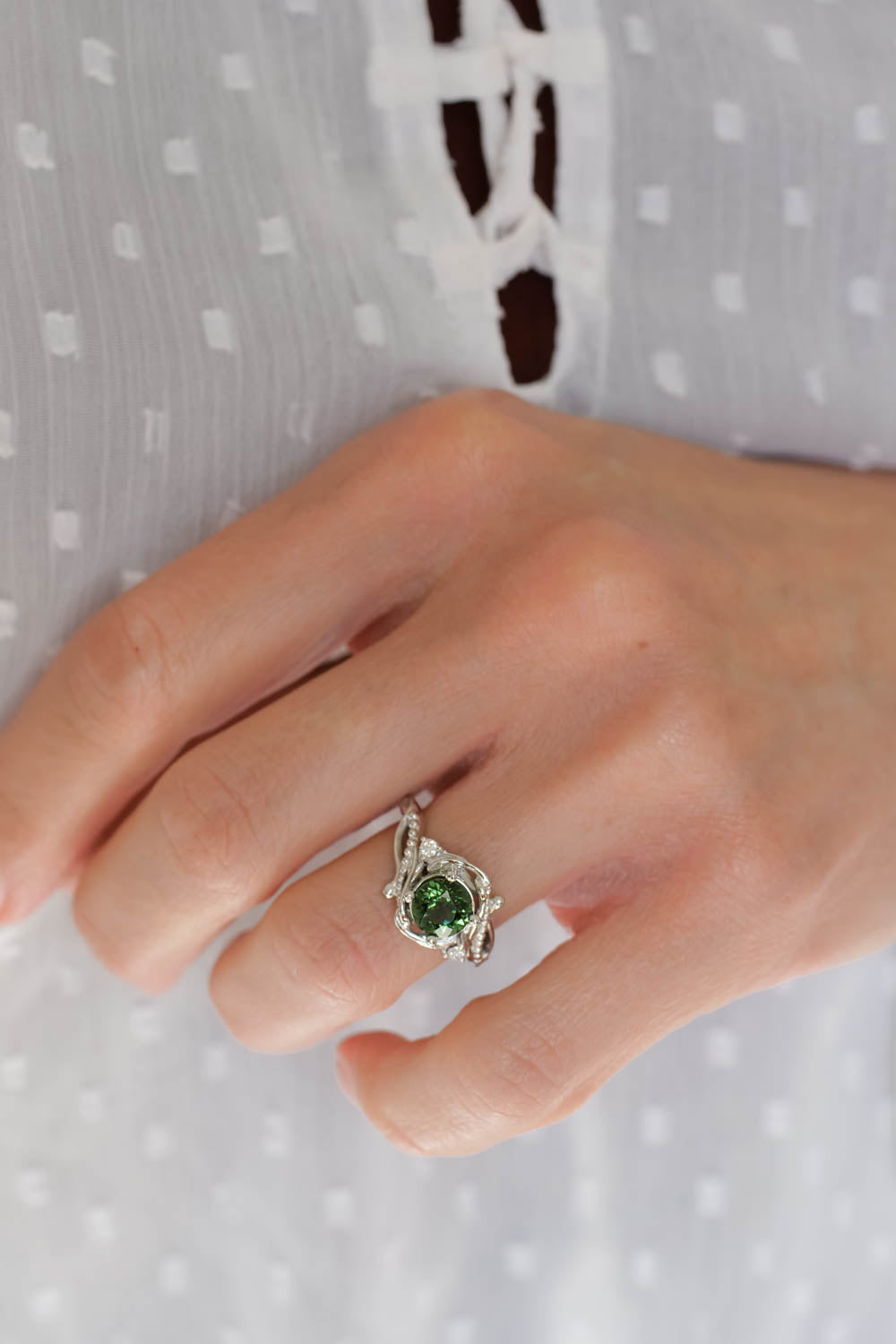 central gemstone of this ring is green tourmaline , round cut, ring in white gold 14K