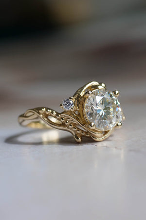 big moissanite engagement ring, elvish style ring with gemstone in the center and moissanites as side stones