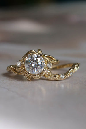 1 carat moissanite engagement ring  in yellow gold with small saide diamonds arround the ring