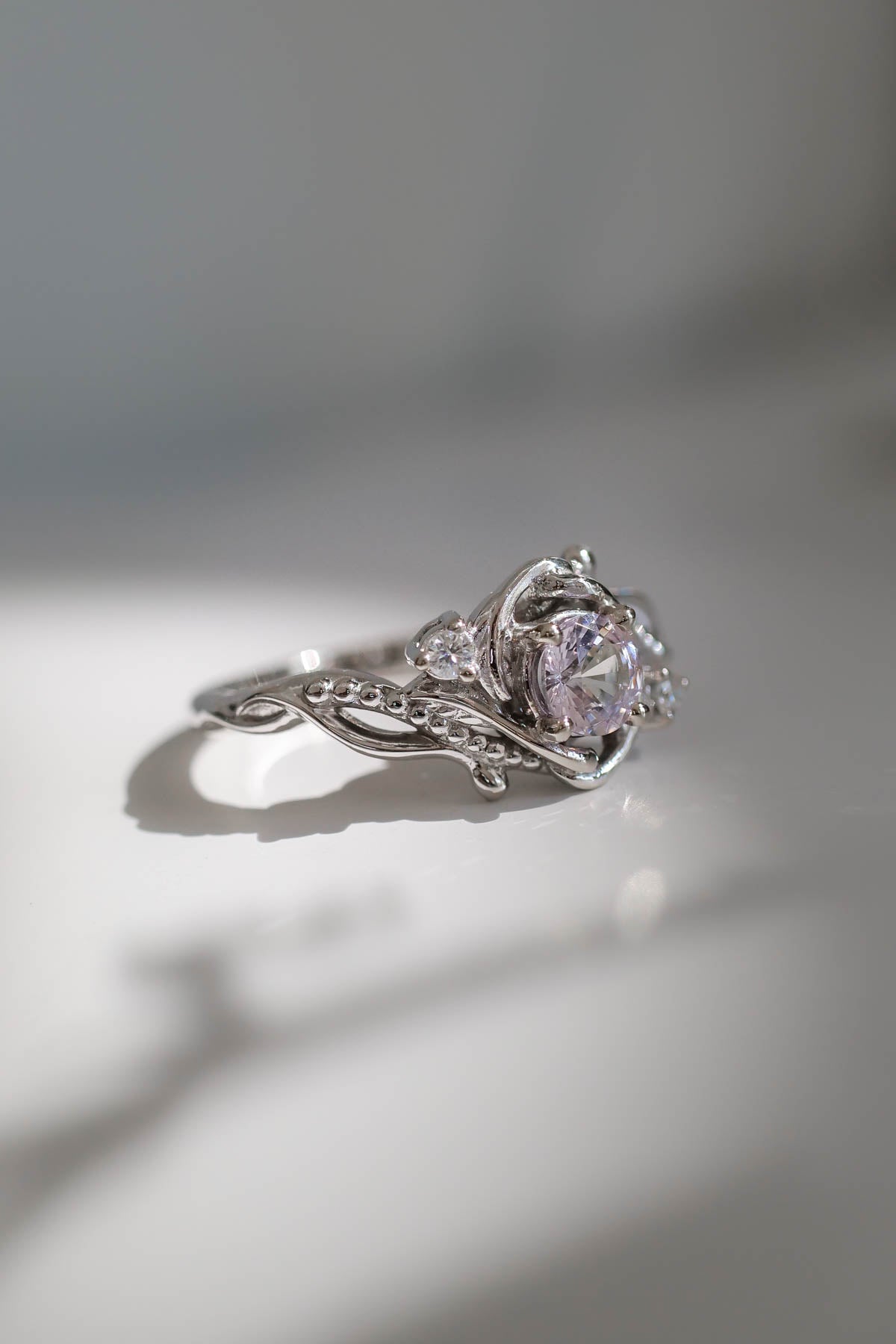 white gold ring with pink sapphire and natural conflict free diamonds