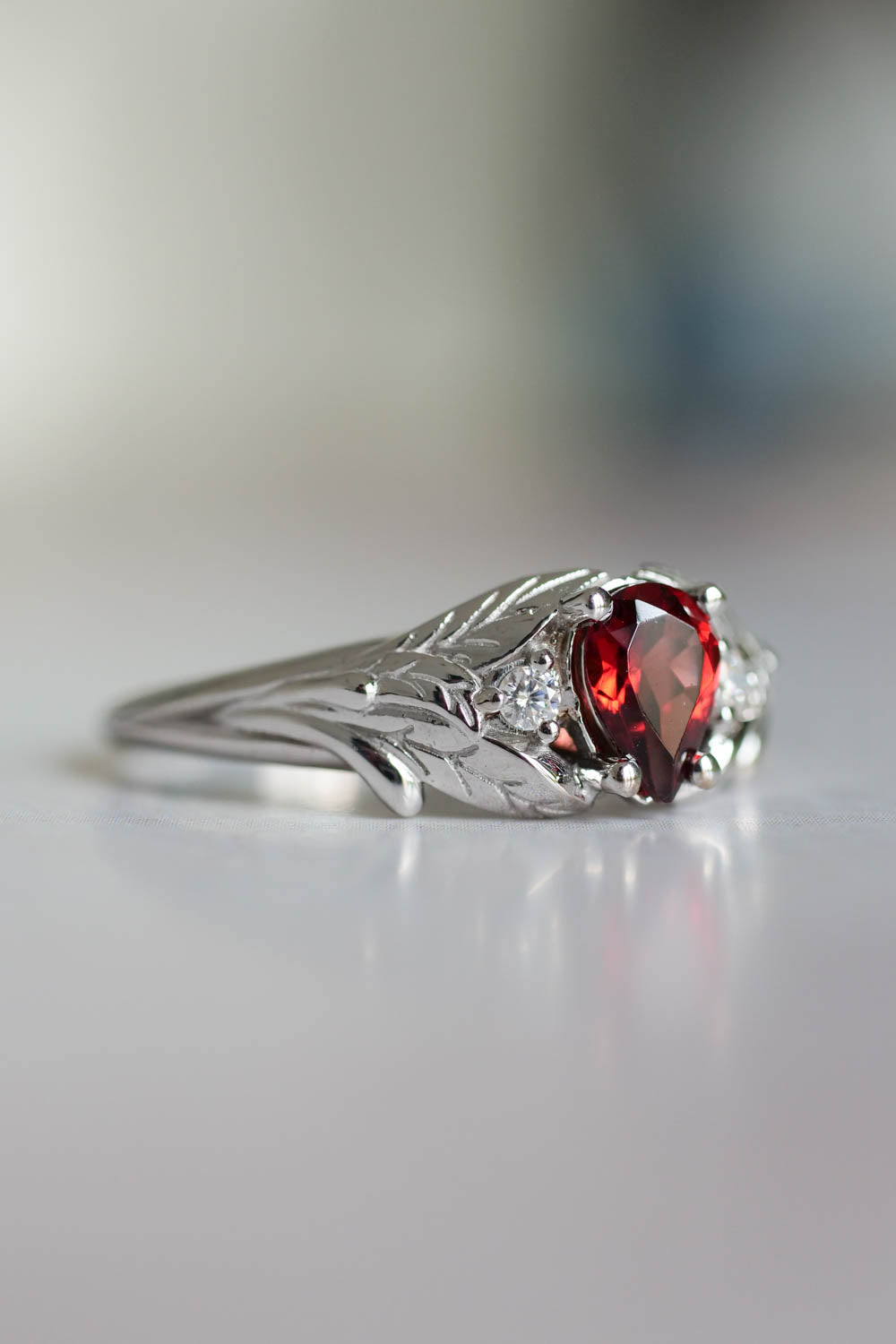 White gold garnet ring with diamonds for engagement 