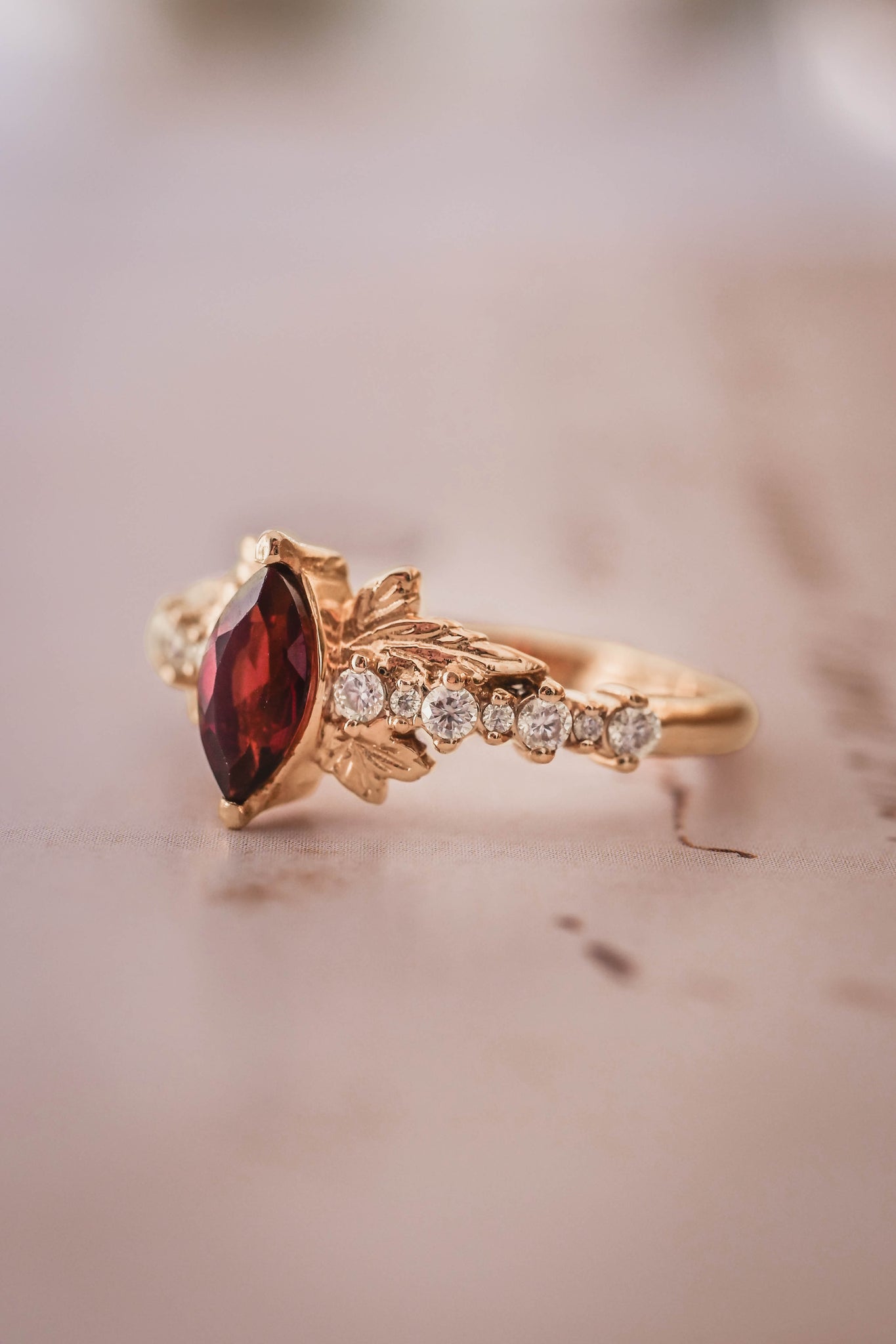 yellow gold engagement ring with  red garnets